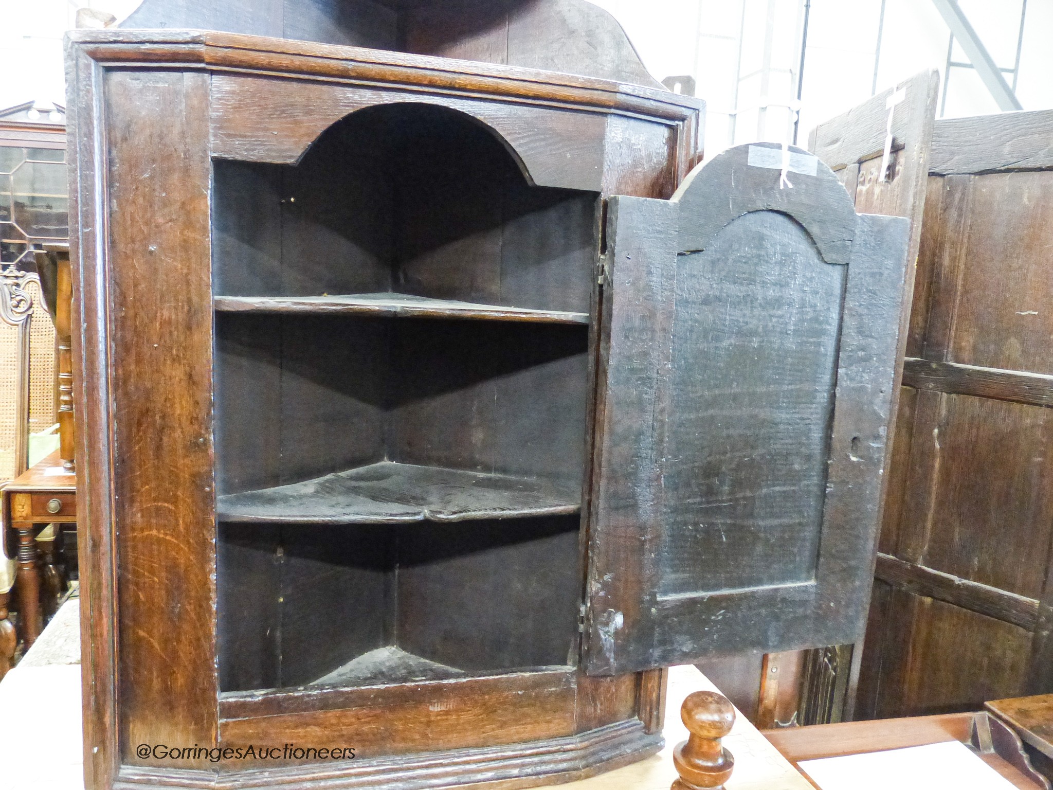 A late 17th century oak hanging corner cupboard